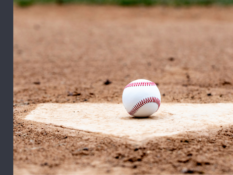 White baseball sitting on a home plate