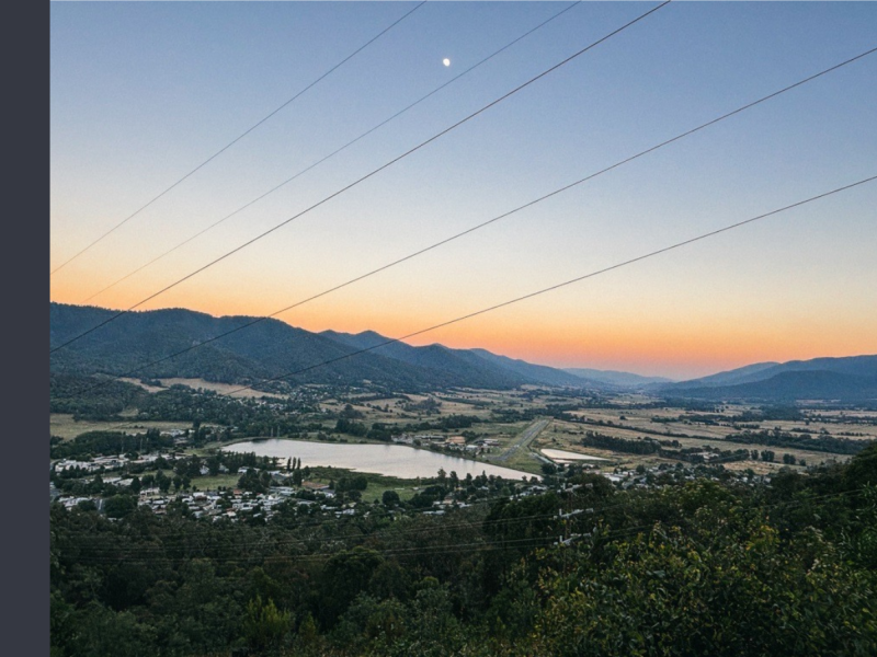 Sunrise over Mount Beauty, with the regulating pondage in view and an orange glow on the horizon.