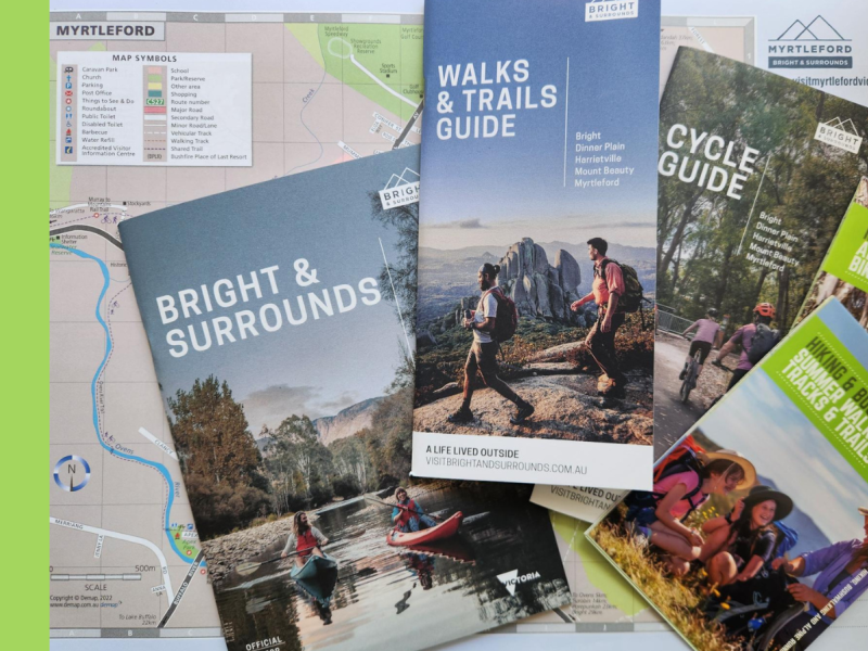 Five tourism brochures for Bright & Surrounds are laid across a map of Myrtleford.