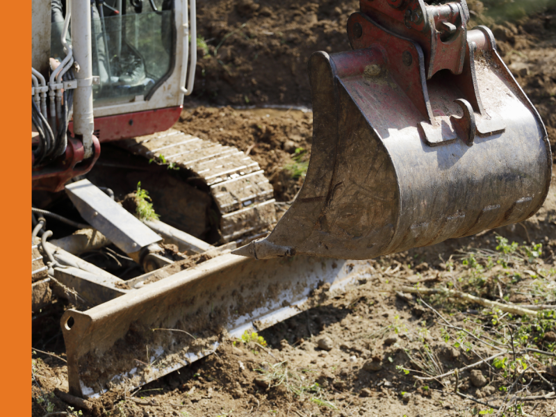 Close up of bulldozer digging in dirt