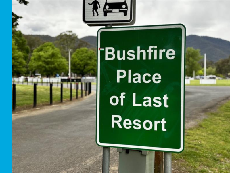 A green sign located at the entry of Pioneer Park Recreation Reserve in Bright with white writing that reads Bushfire Place of Last Resort.