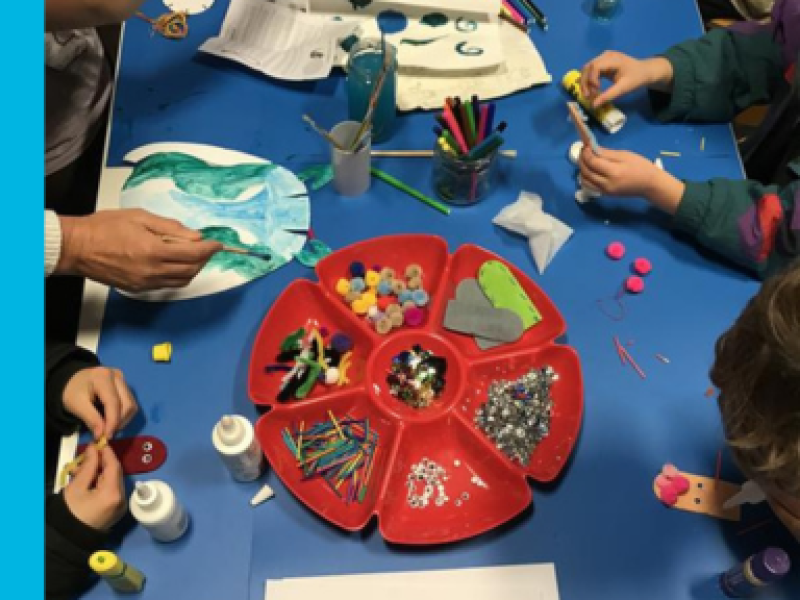 Children reaching for different craft supplies whilst doing craft activities at our library.