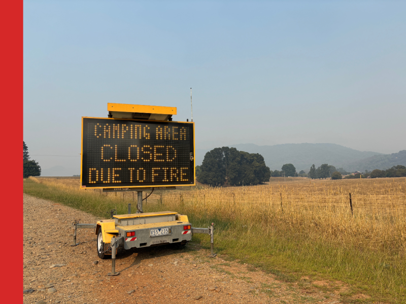 A VMS board on the side of a road with the words Camping Area CLOSED Due to Fire.