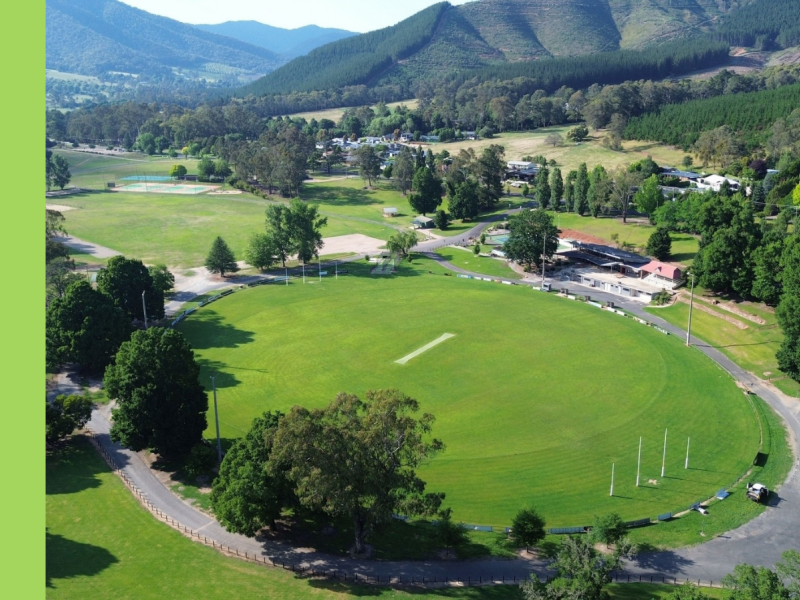 A drone image of a sporting oval with hills in the background.
