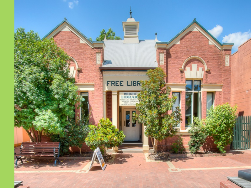 A red brick single-storey building that says Free Library across the top.