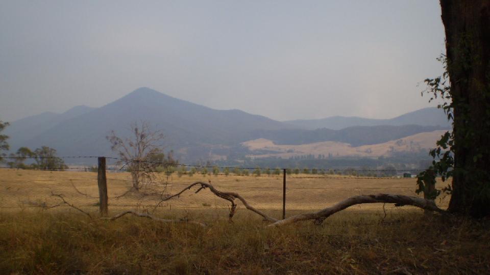 Hazy smoke over farmland in Dederang or Upper Gundowring during or following a bushfire.