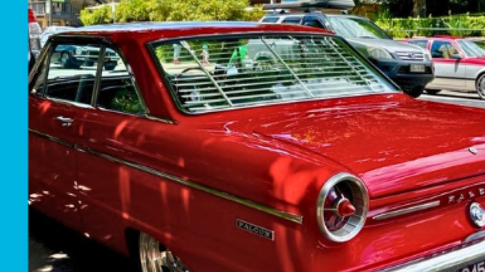 Red vintage car parked in the main street of Bright